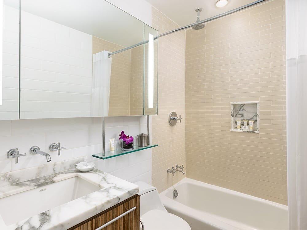 1401 Simonton Street, Unit 11 Key West, FL 33040 - Photo 8 of 17 a bathroom with a granite countertop sink a mirror and a bathtub