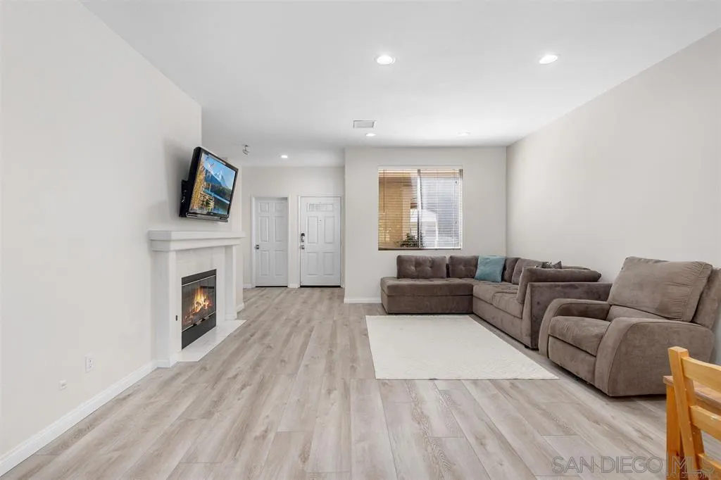 12530 Heatherton Court, Unit 31 San Diego, CA 92128 - Photo 12 of 36 a living room with furniture a fireplace and a flat screen tv
