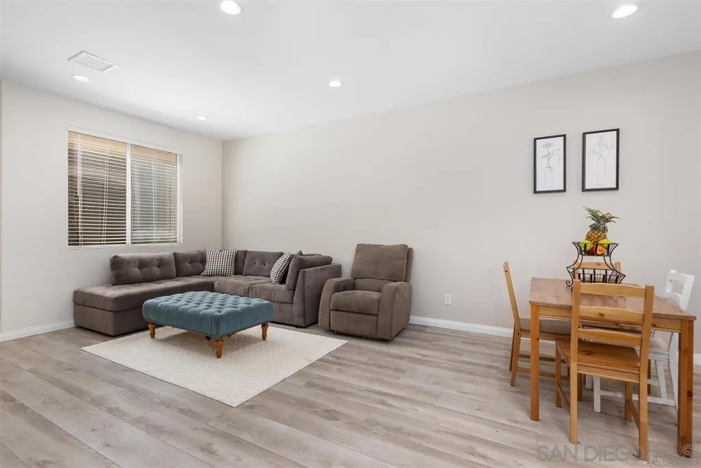 12530 Heatherton Court, Unit 31 San Diego, CA 92128 - Photo 13 of 36 a living room with furniture and a wooden floor
