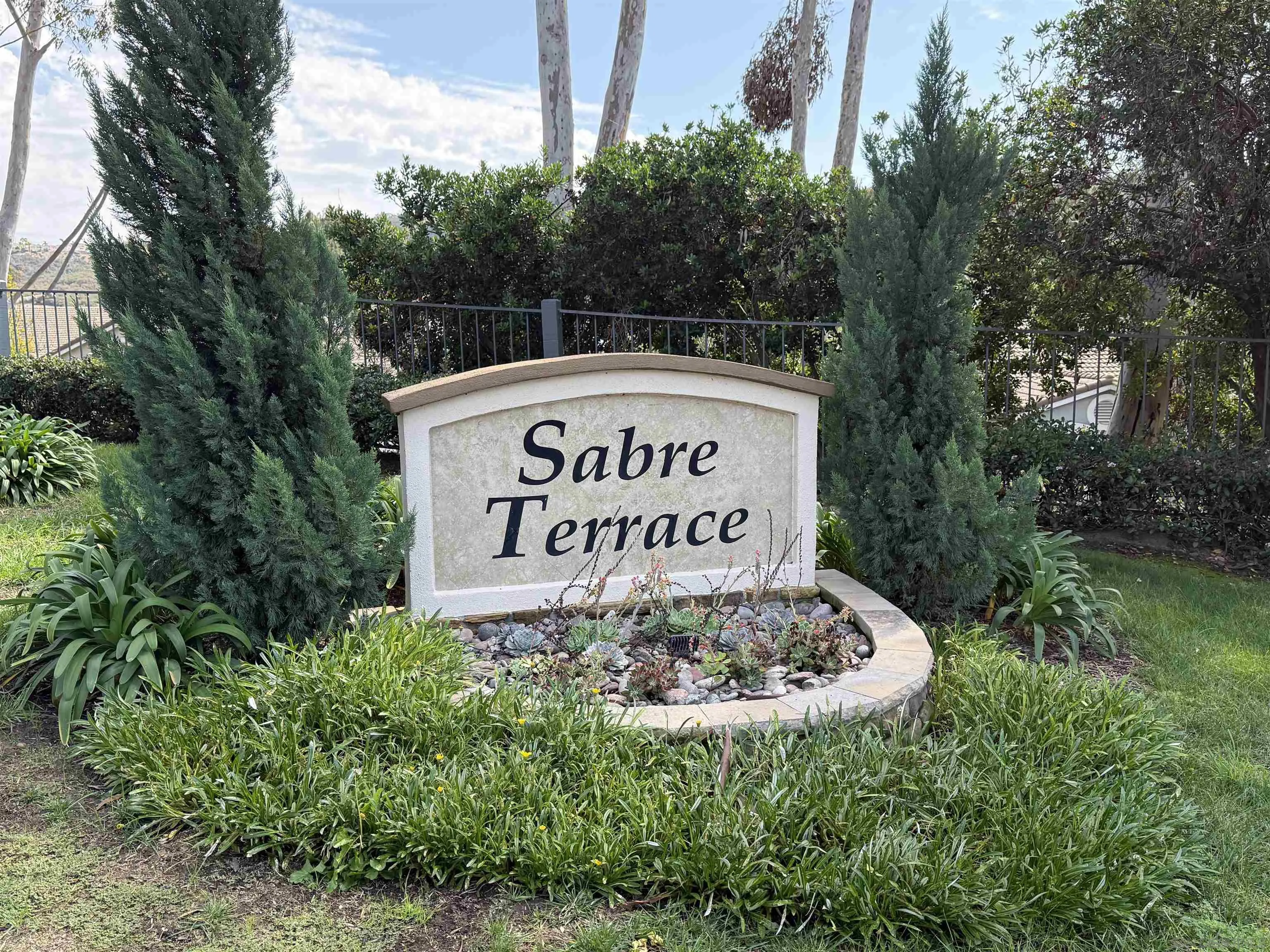 12530 Heatherton Court, Unit 31 San Diego, CA 92128 - Photo 14 of 36 a sign of golf club on a wall under a tree