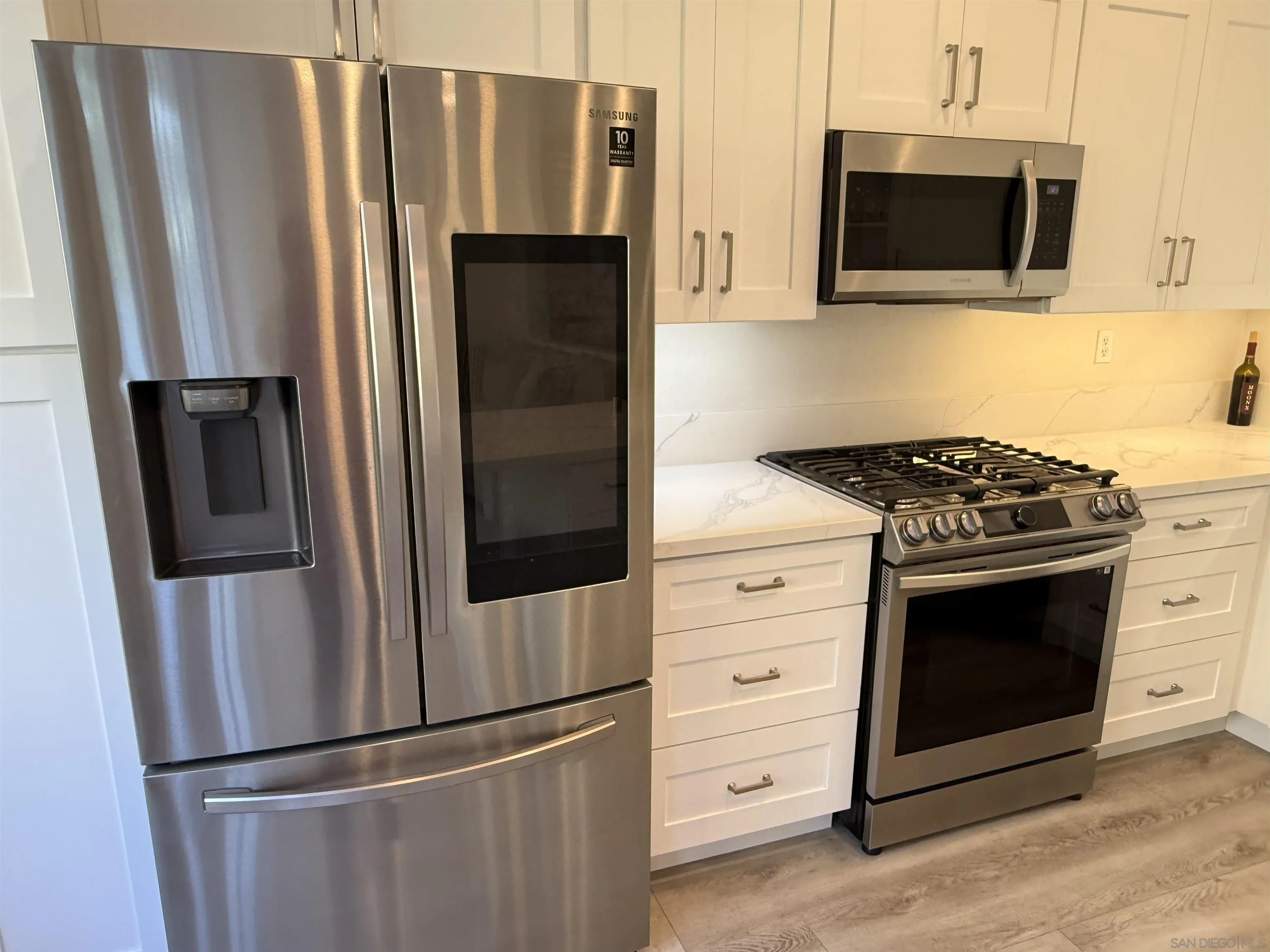 12530 Heatherton Court, Unit 31 San Diego, CA 92128 - Photo 16 of 36 a kitchen with stainless steel appliances a refrigerator stove and microwave