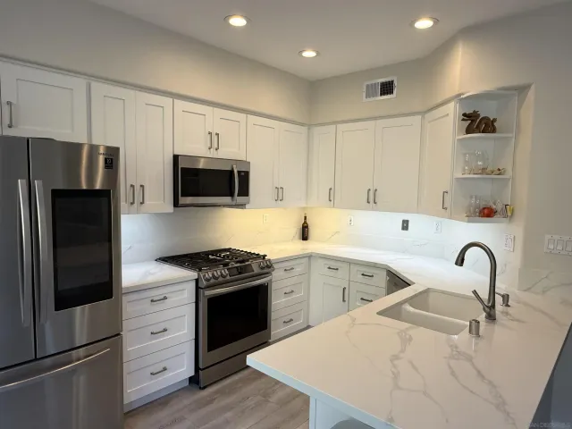 a kitchen with a sink stove and refrigerator
