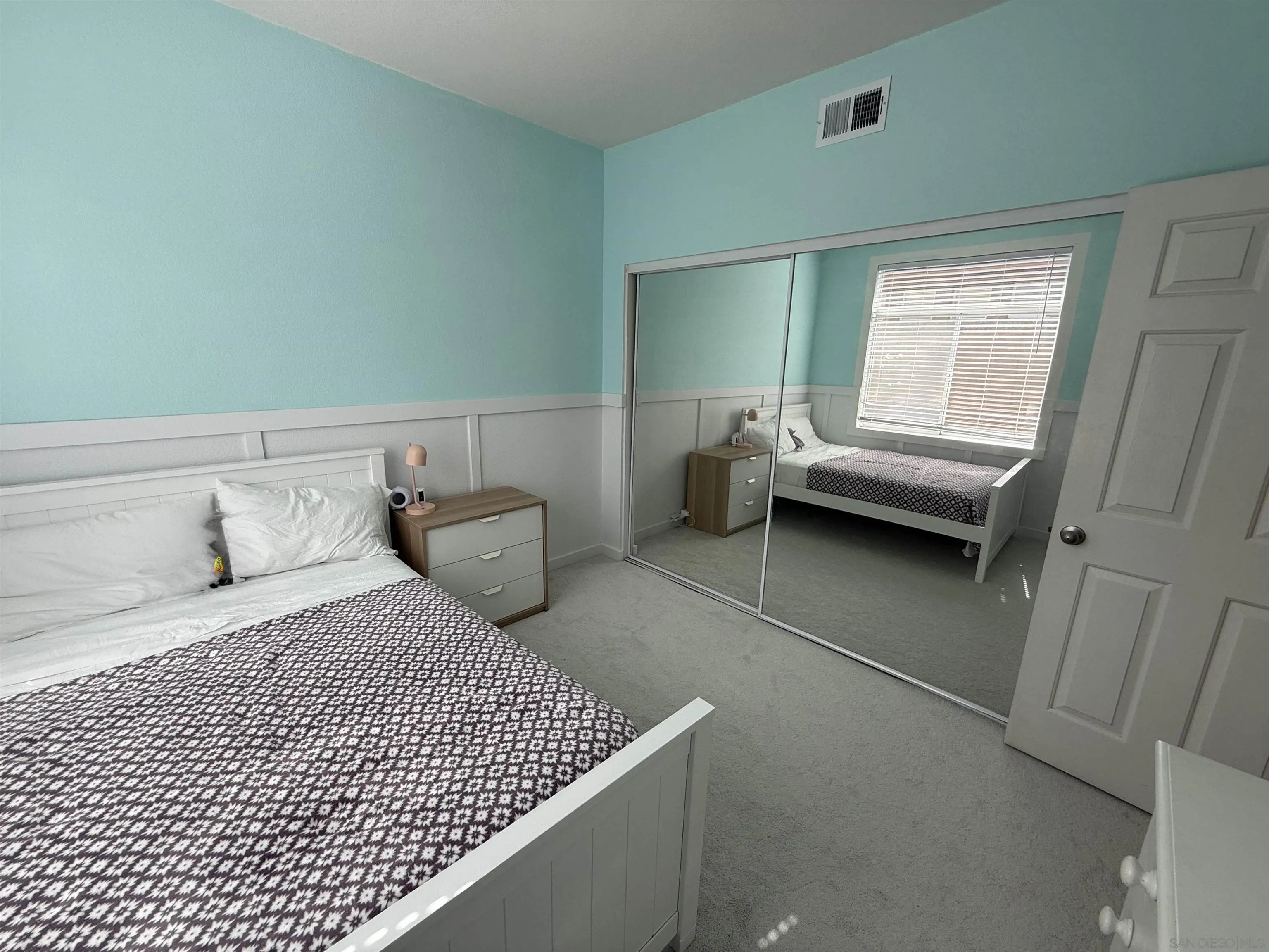 12530 Heatherton Court, Unit 31 San Diego, CA 92128 - Photo 25 of 36 a bedroom with a bed and a window