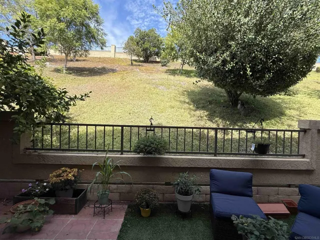a view of a chairs and table in patio