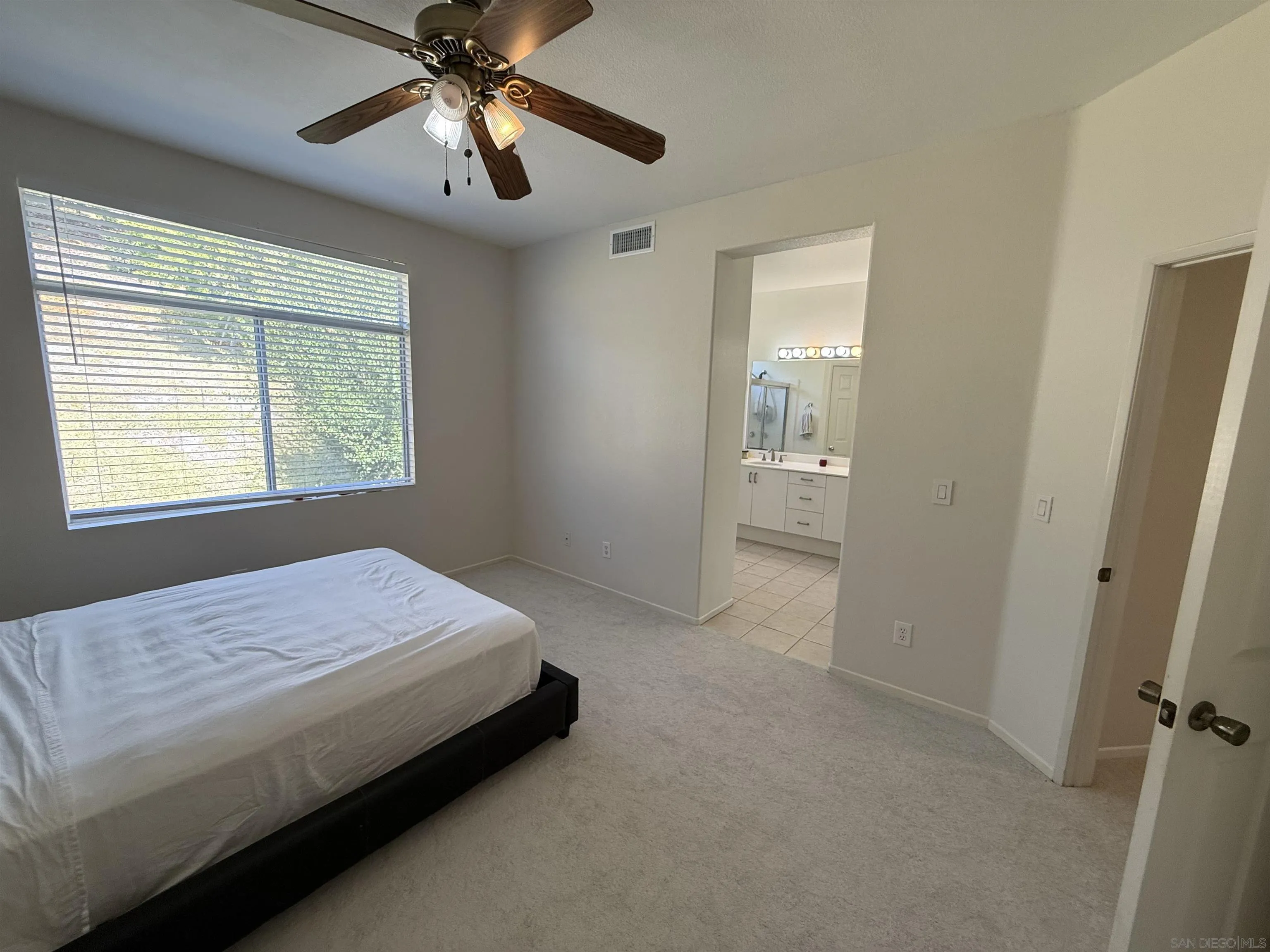 12530 Heatherton Court, Unit 31 San Diego, CA 92128 - Photo 29 of 36 a bedroom with a bed and a chandelier