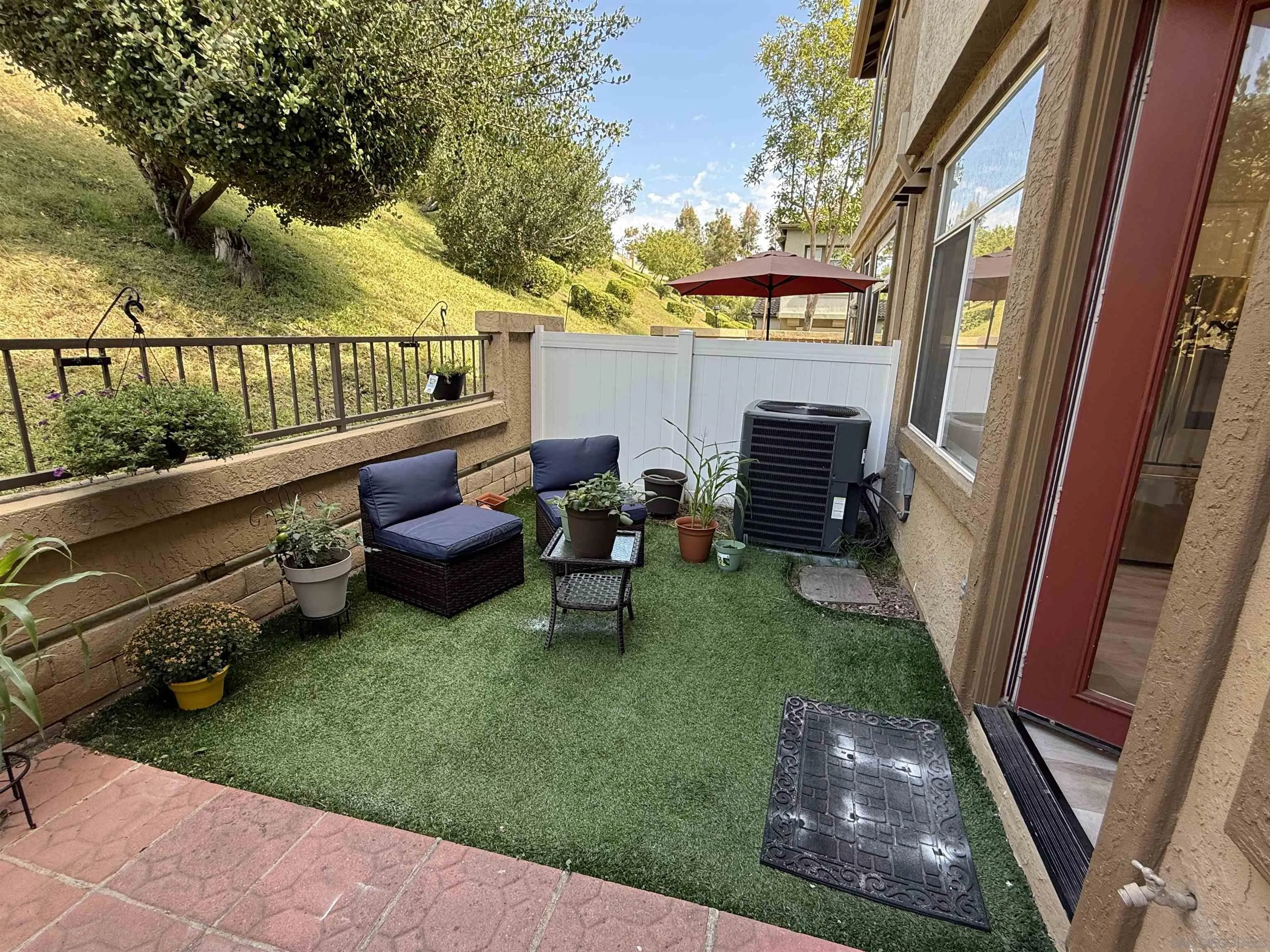12530 Heatherton Court, Unit 31 San Diego, CA 92128 - Photo 3 of 36 a view of a patio with chairs and a yard