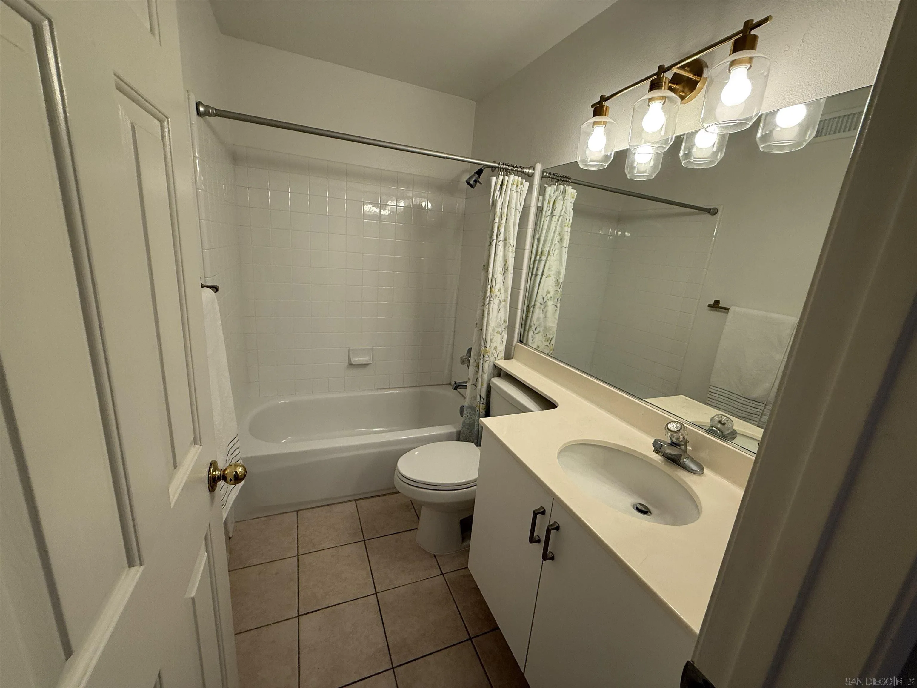 12530 Heatherton Court, Unit 31 San Diego, CA 92128 - Photo 31 of 36 a bathroom with a sink a toilet a mirror a vanity and shower