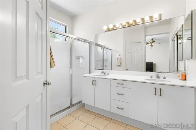a bathroom with a double vanity sink mirror and