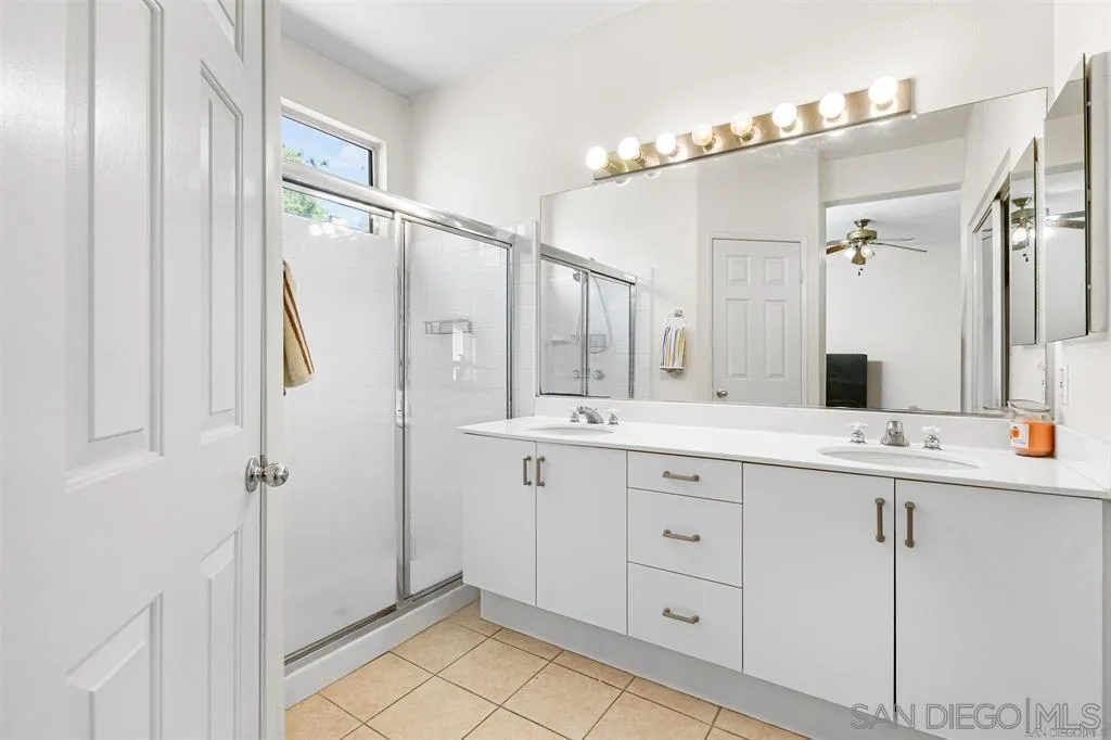 12530 Heatherton Court, Unit 31 San Diego, CA 92128 - Photo 6 of 36 a bathroom with a double vanity sink mirror and