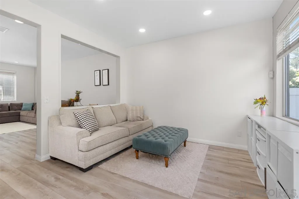 12530 Heatherton Court, Unit 31 San Diego, CA 92128 - Photo 7 of 36 a living room with furniture and a wooden floor