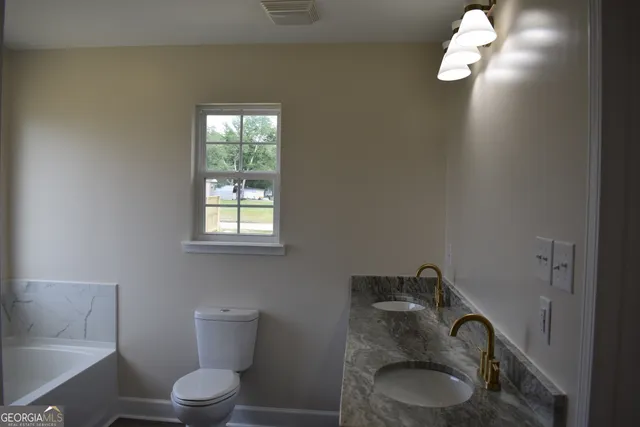 a white toilet sitting next to a window
