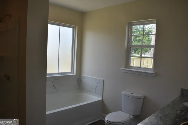 a bathroom with a bathtub and shower
