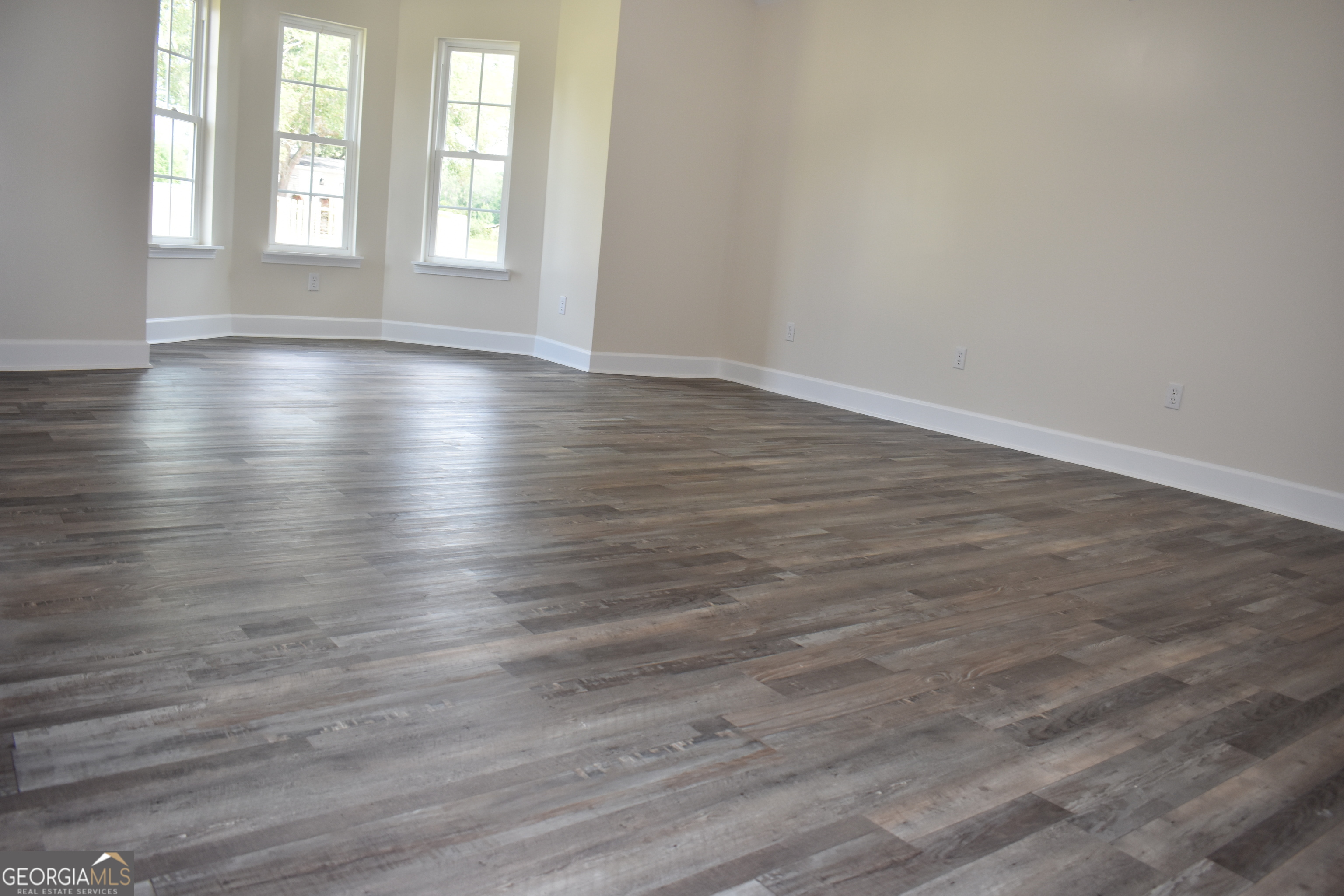 537 Quick Run Road Reidsville, GA 30453 - Photo 15 of 42 a view of an empty room with wooden floor and window
