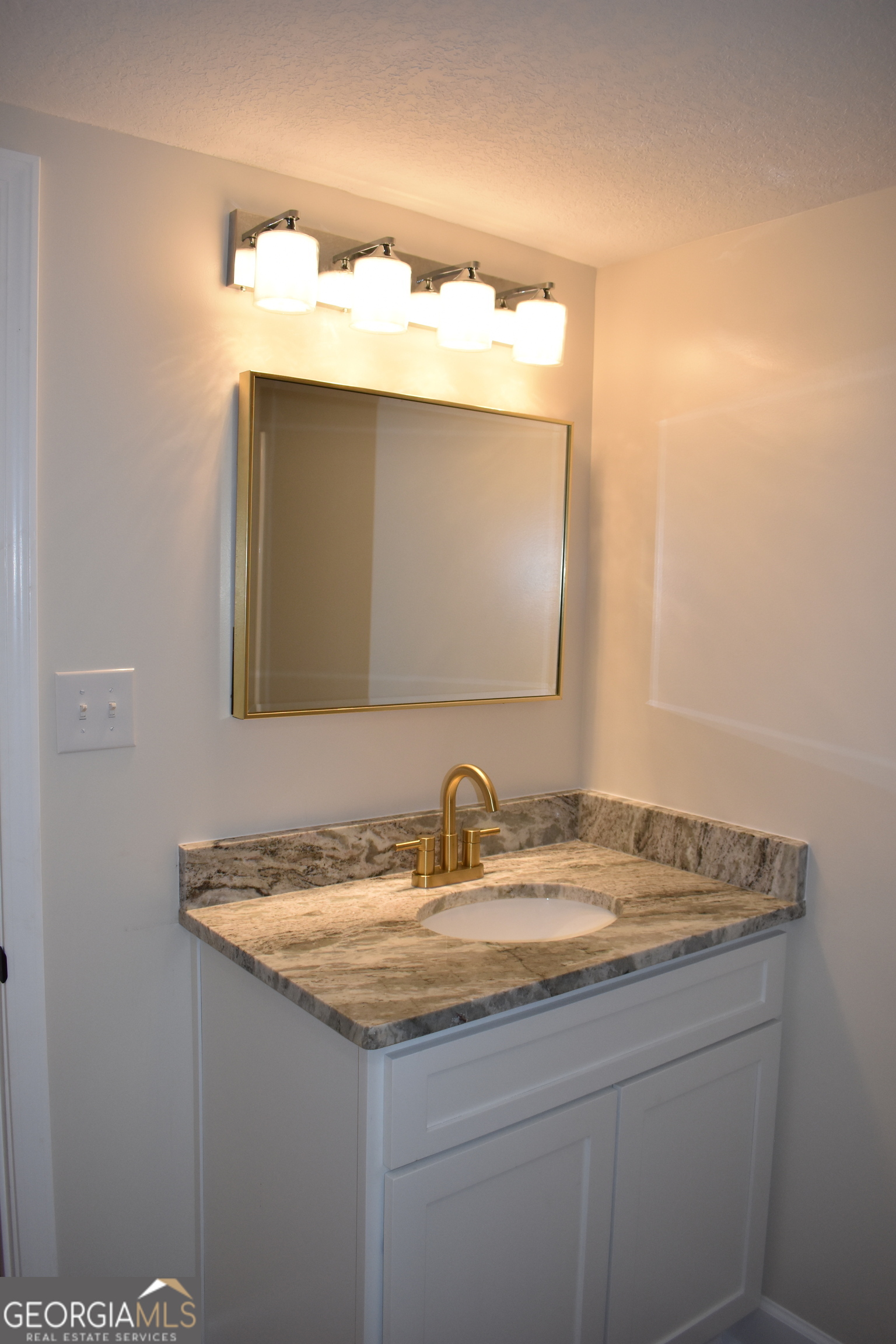 537 Quick Run Road Reidsville, GA 30453 - Photo 22 of 42 a bathroom with a granite countertop sink and a mirror