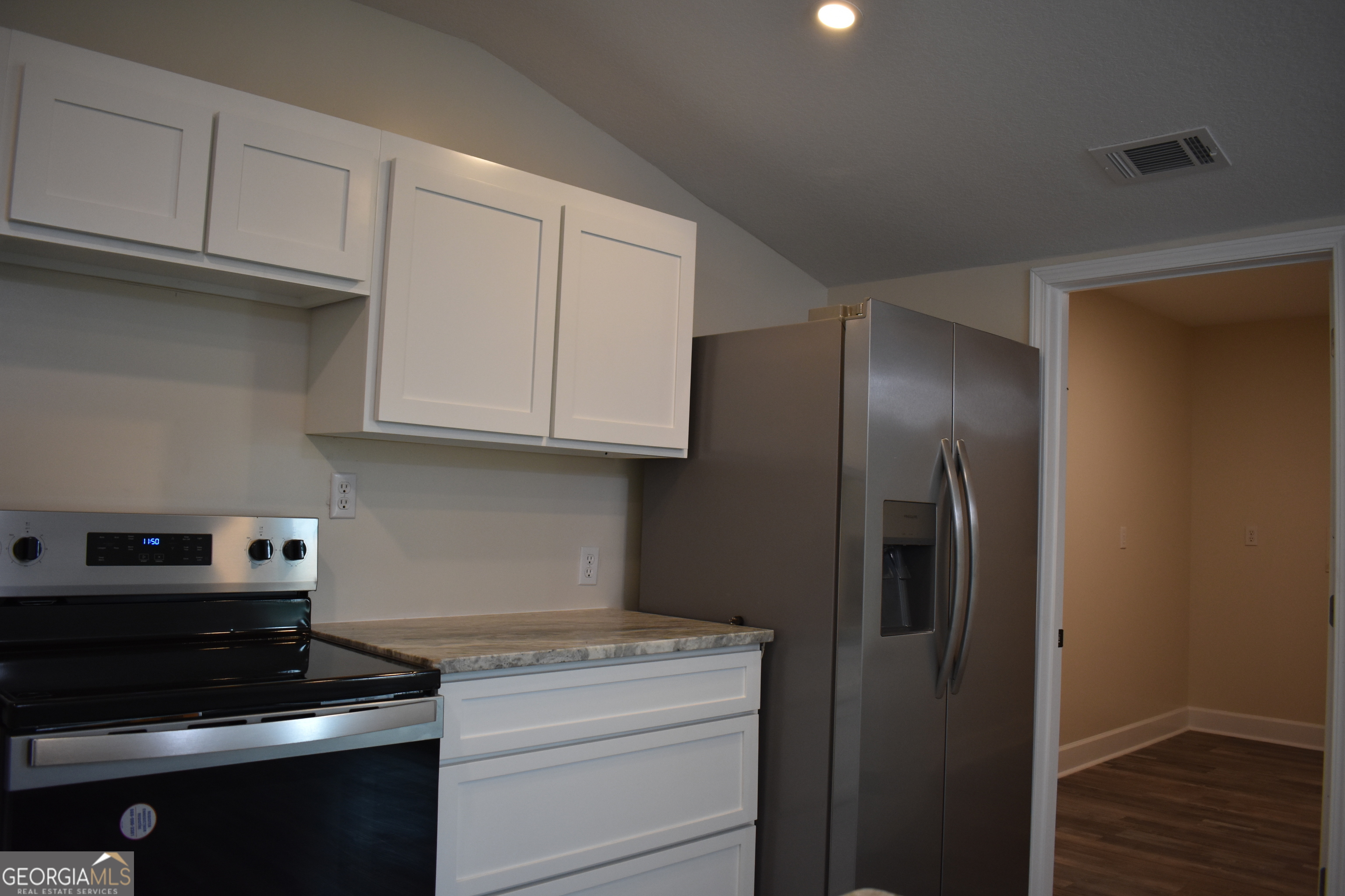 537 Quick Run Road Reidsville, GA 30453 - Photo 24 of 42 a kitchen with stainless steel appliances granite countertop white cabinets and a stove