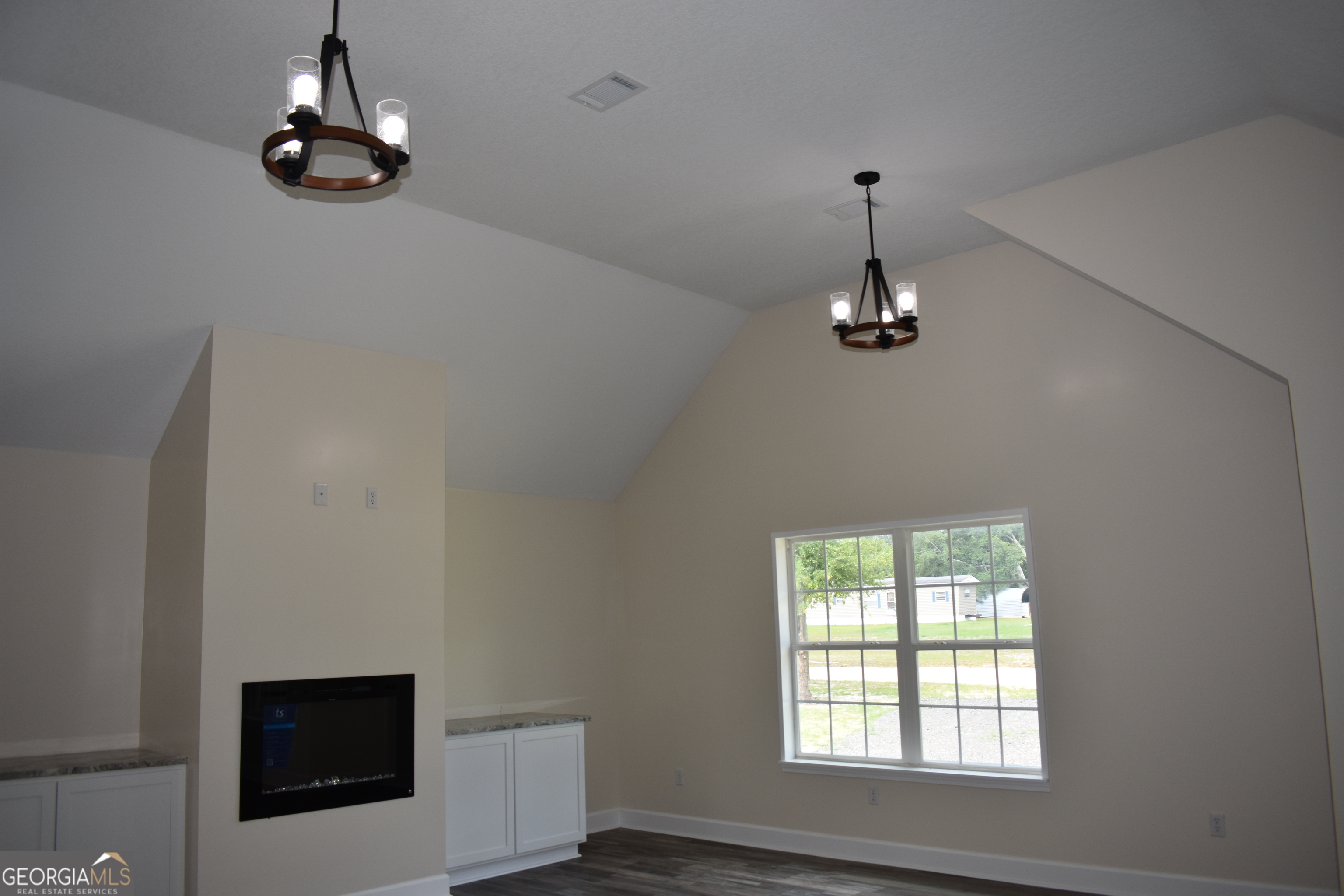 537 Quick Run Road Reidsville, GA 30453 - Photo 28 of 42 a room with a window and a chandelier