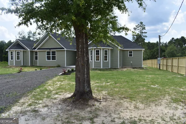 a front view of house with yard and green space
