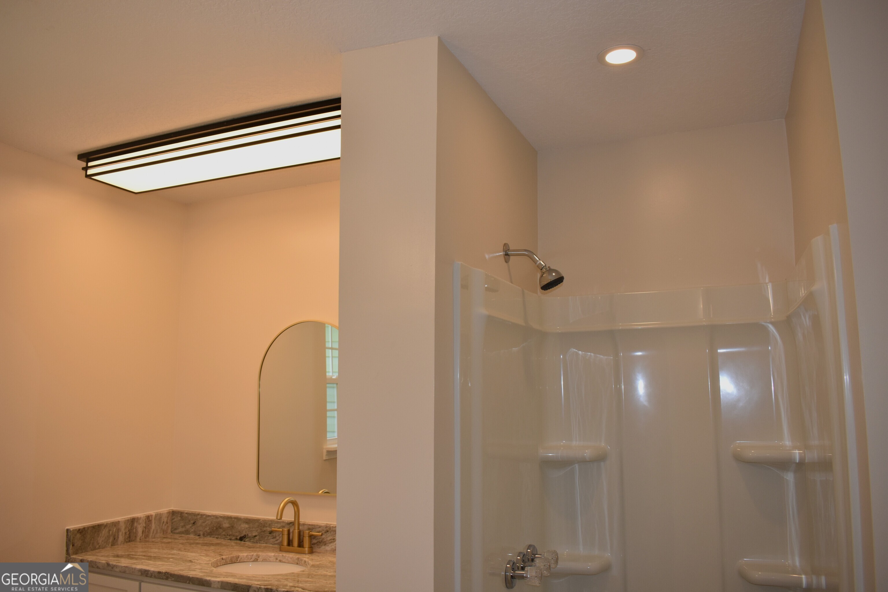 537 Quick Run Road Reidsville, GA 30453 - Photo 32 of 42 a bathroom with a mirror and a shower