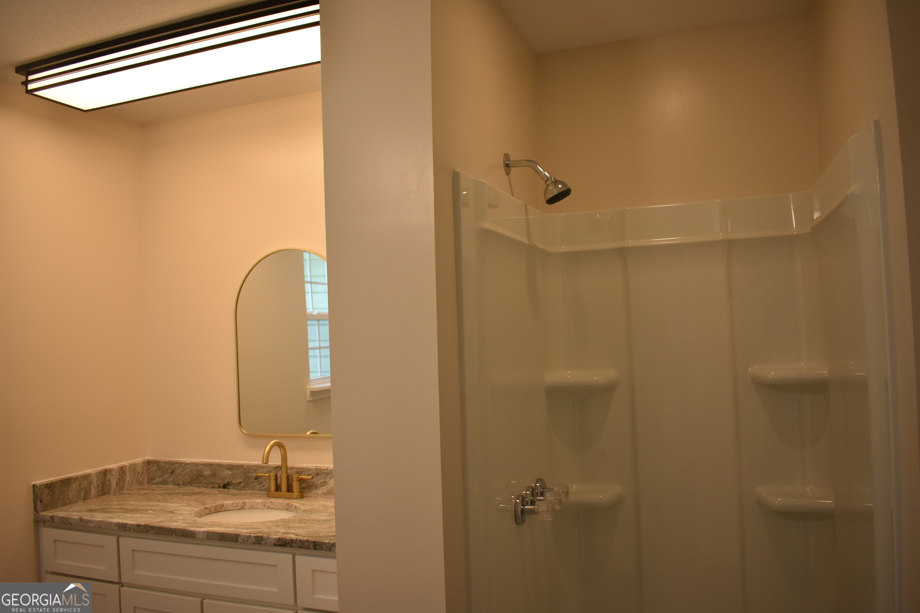 537 Quick Run Road Reidsville, GA 30453 - Photo 34 of 42 a bathroom with a granite countertop sink and a mirror