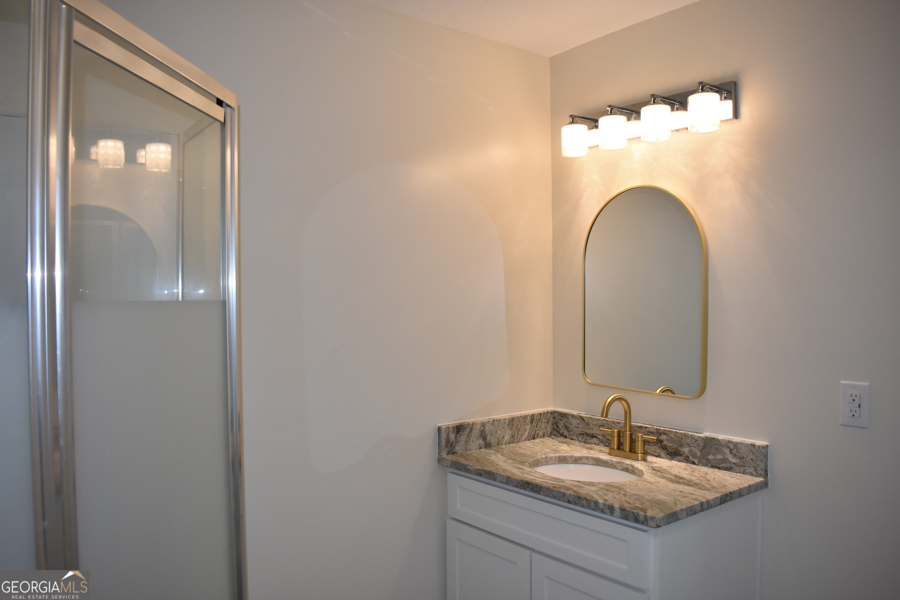 537 Quick Run Road Reidsville, GA 30453 - Photo 38 of 42 a bathroom with a sink and a mirror