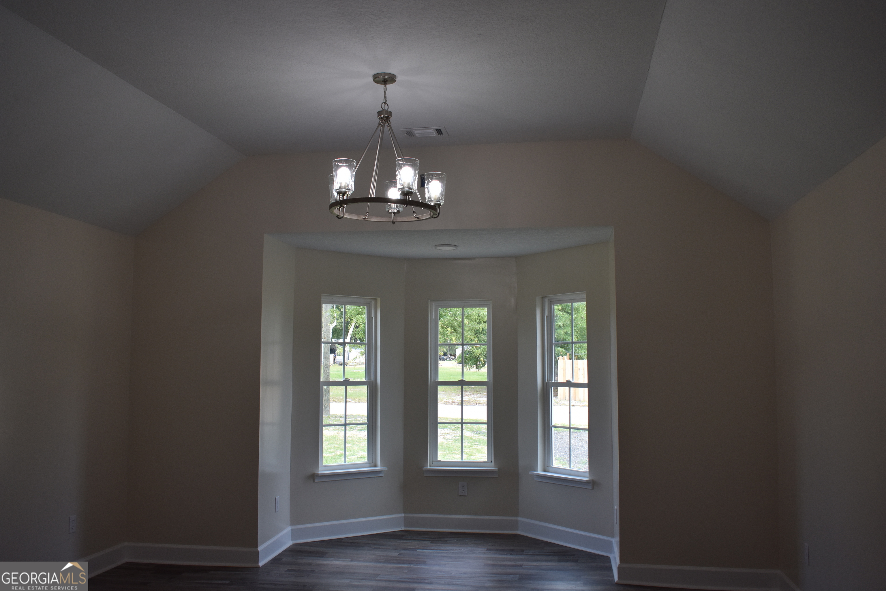 537 Quick Run Road Reidsville, GA 30453 - Photo 10 of 42 a view of a chandelier and wooden floor in windows