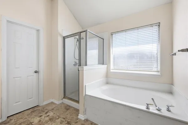a bathroom with a bathtub and a shower