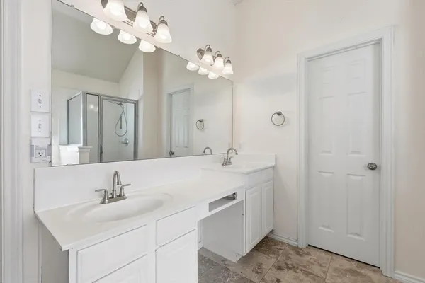 a bathroom with a double vanity sink and a mirror