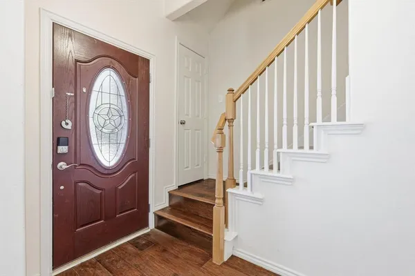 a view of an entryway with wooden floor