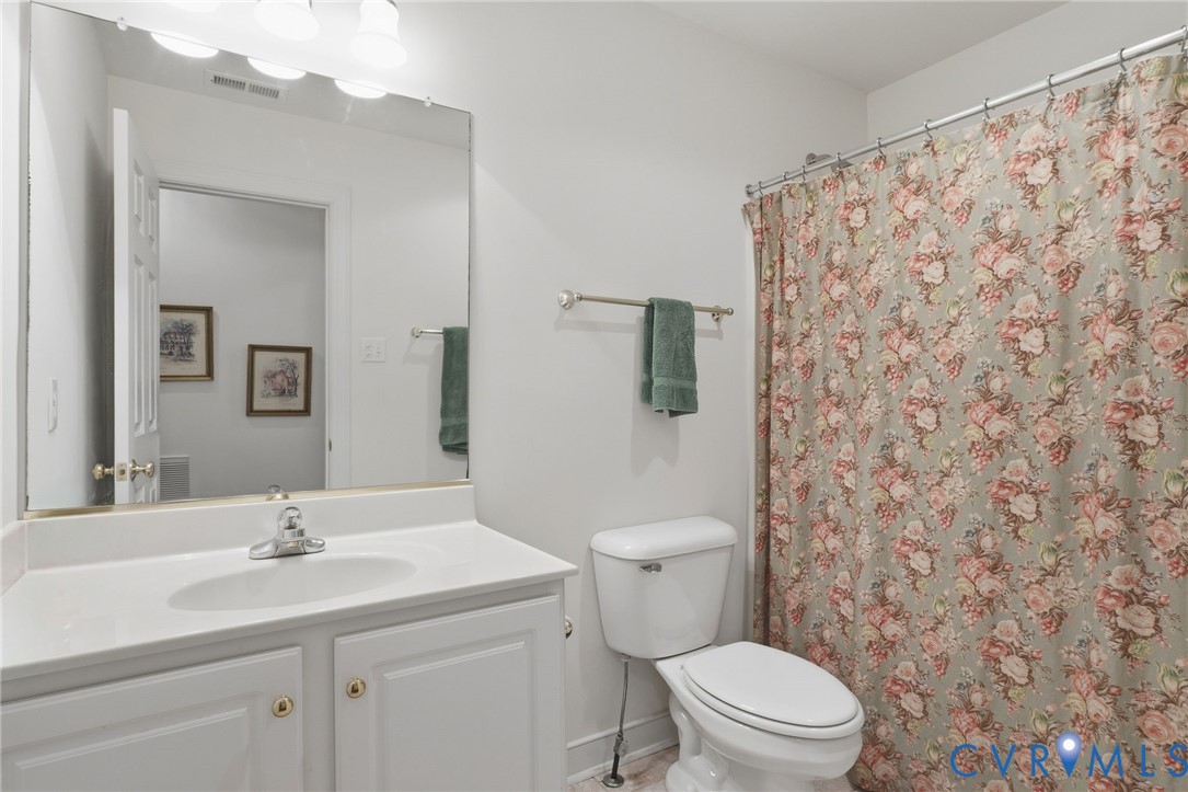 13424 Tipple Point Road Midlothian, VA 23114 - Photo 34 of 53 a bathroom with a sink a toilet and a mirror