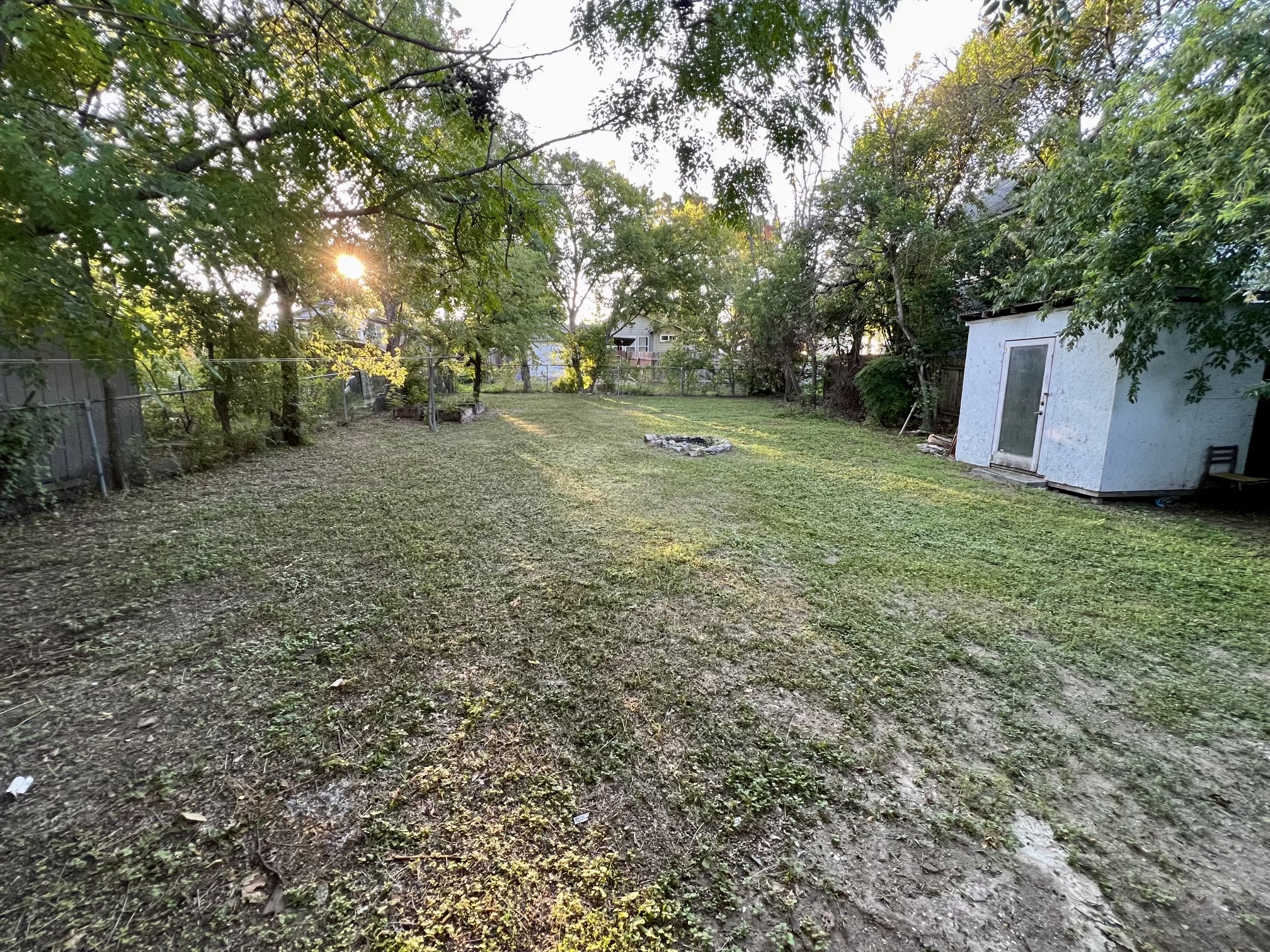 5409 Link Avenue Austin, TX 78751 - Photo 2 of 10 Fenced backyard featuring an outbuilding and view of wooded area
