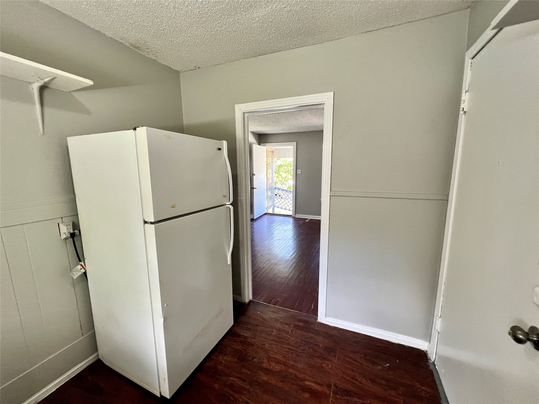 5409 Link Avenue Austin, TX 78751 - Photo 6 of 10 Kitchen featuring freestanding refrigerator, dark wood finished floors, and a textured ceiling