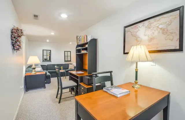 a room with furniture pool table and painting on the wall