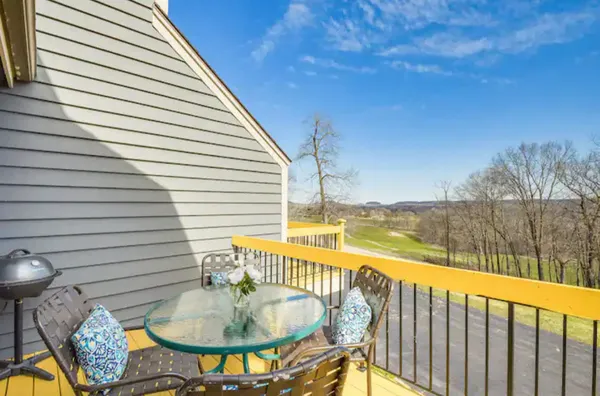 a balcony with table and chairs