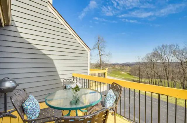 a balcony with table and chairs