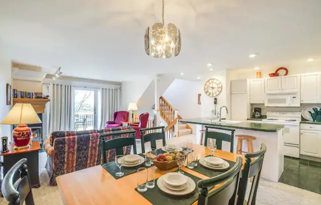 a view of a dining room with furniture and a chandelier