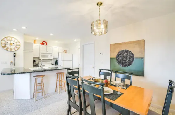 an open kitchen with a table and chairs
