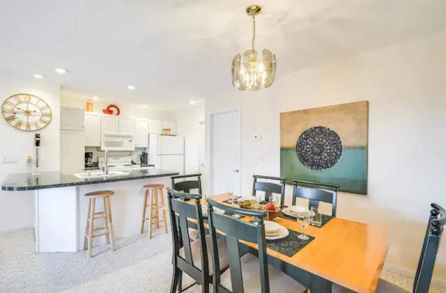 an open kitchen with a table and chairs