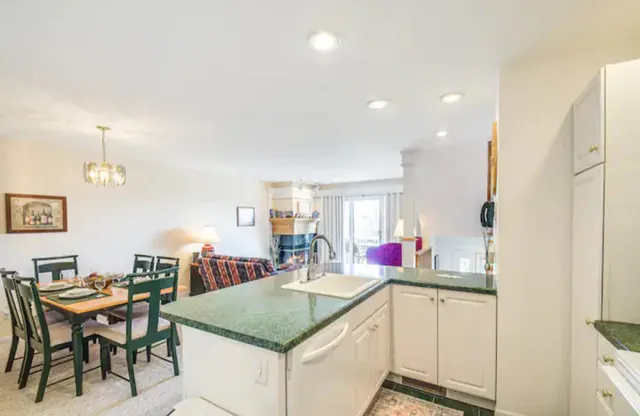 a kitchen view with table and chairs