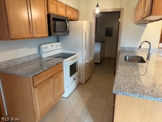 97 Park Road Painesville, OH 44077 - Photo 12 of 18 Kitchen featuring light stone counters, white electric range, stainless steel microwave, pendant lighting, and light tile patterned floors