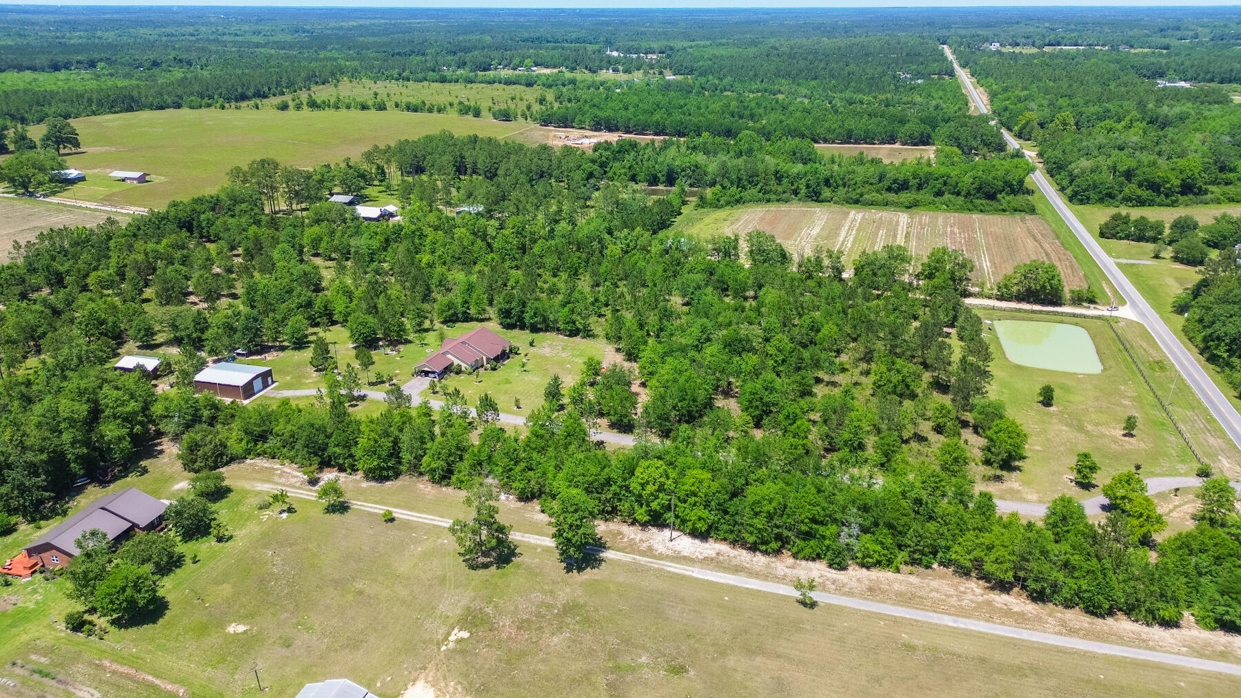 1428 Piney Grove Road Chipley, FL 32428 - Photo 45 of 58 an aerial view of lake residential house with swimming pool and outdoor space
