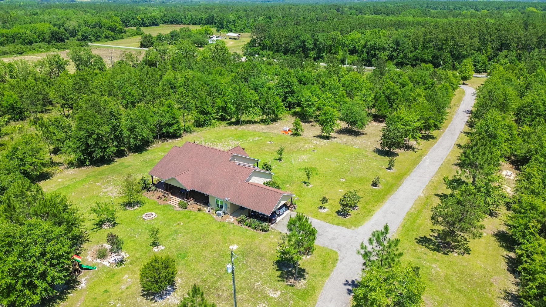 1428 Piney Grove Road Chipley, FL 32428 - Photo 55 of 58 an aerial view of residential houses with outdoor space and trees all around