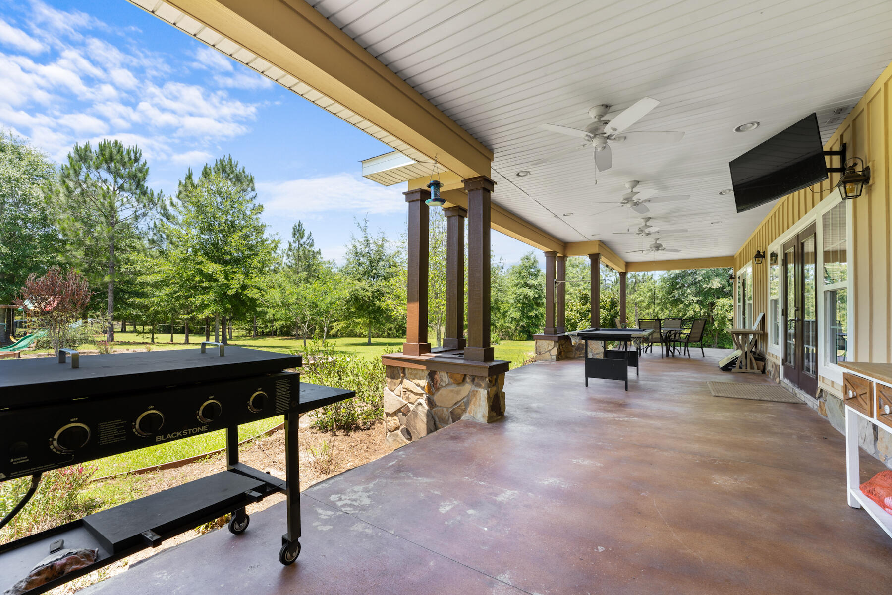 1428 Piney Grove Road Chipley, FL 32428 - Photo 8 of 58 a view of a patio with a table and chairs