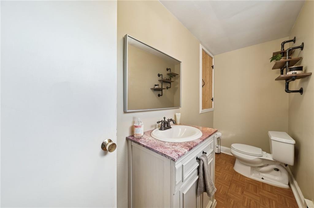 3454 Rigel Street Pittsburgh, PA 15212 - Photo 19 of 37 a bathroom with a granite countertop sink and a mirror with toilet