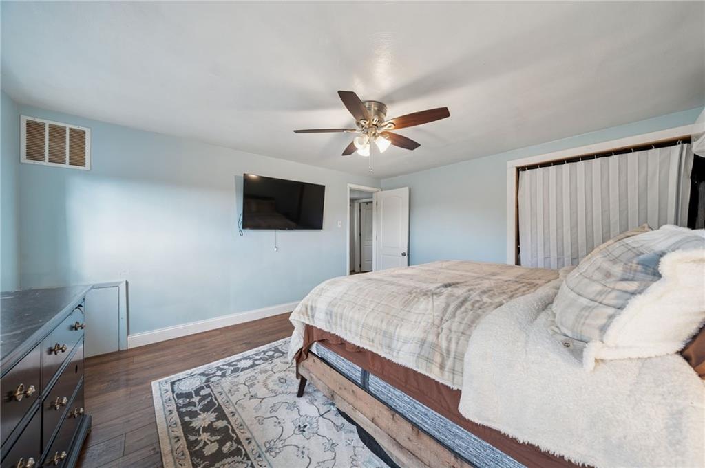 3454 Rigel Street Pittsburgh, PA 15212 - Photo 23 of 37 a bedroom with a bed and a flat screen tv