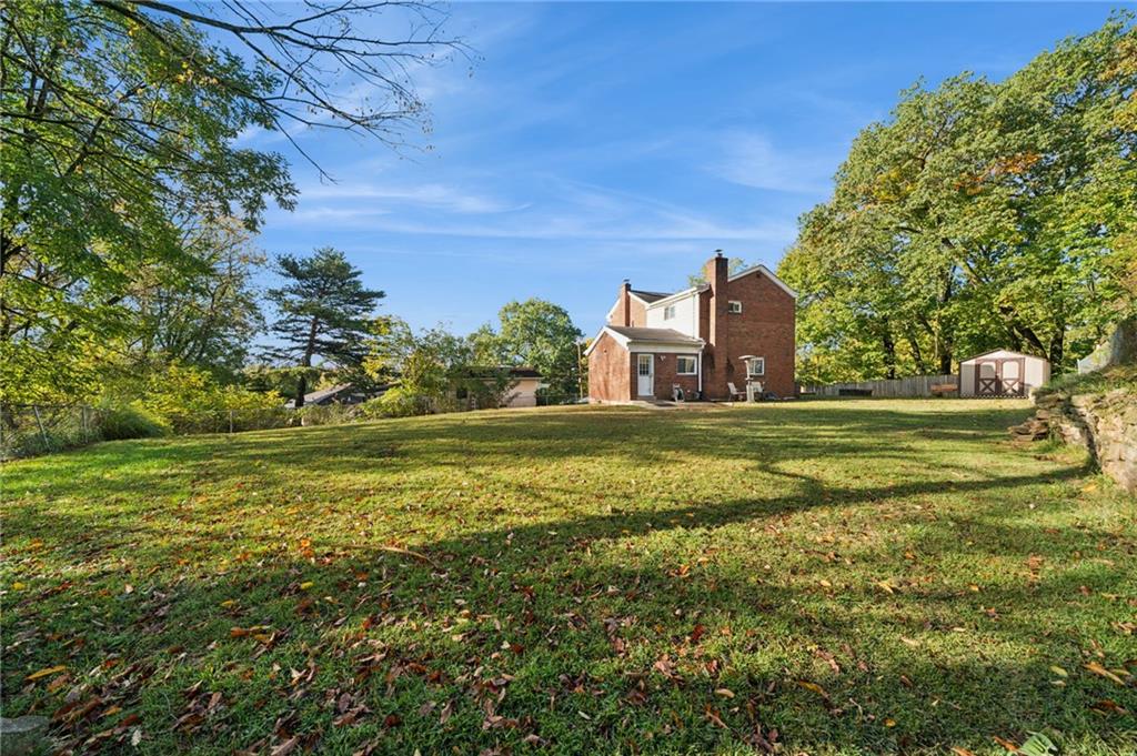 3454 Rigel Street Pittsburgh, PA 15212 - Photo 5 of 37 a view of a big house with a big yard and large trees
