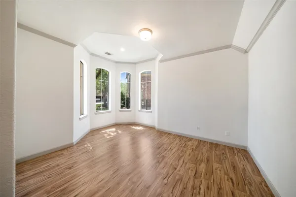 a view of livingroom with an entryway and wooden floor