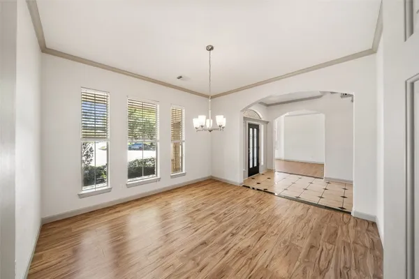 a large kitchen with stainless steel appliances a refrigerator a sink and a stove