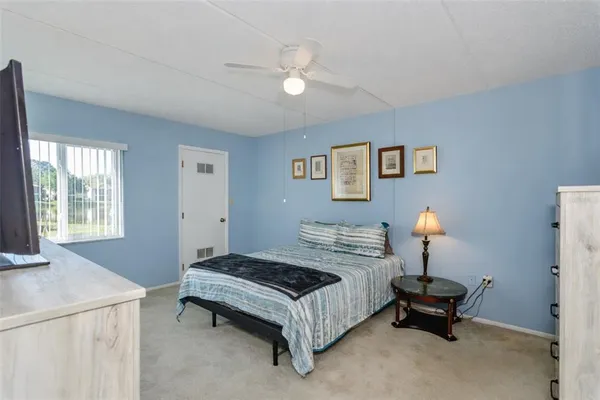 a bedroom with a bed and flat screen tv