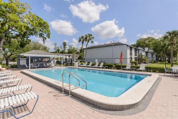 a view of a swimming pool with a lounge chair