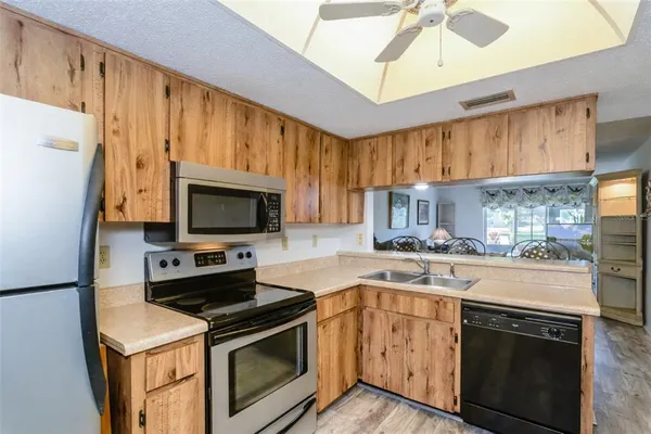 a kitchen with stainless steel appliances a stove a sink and a refrigerator